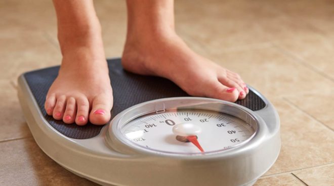Female feet on weight scale