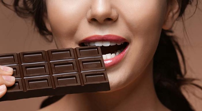 girl eating dark chocolate